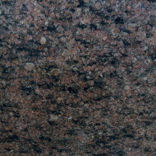 Kemet Brown granite slab face, photographed for the factory catalog — deep grey overall.