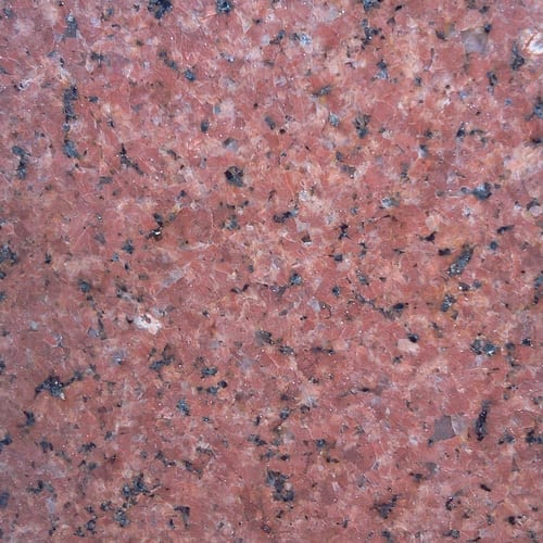 Royal granite slab face, photographed for the factory catalog — mid-toned red overall.