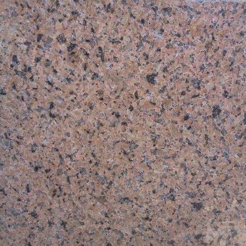 Shabah Yellow granite slab face, photographed for the factory catalog — mid-toned red overall.