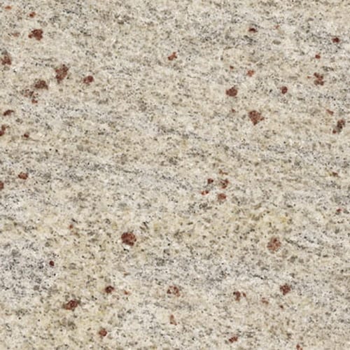 Cashmir White granite slab face, photographed for the factory catalog — light amber overall.