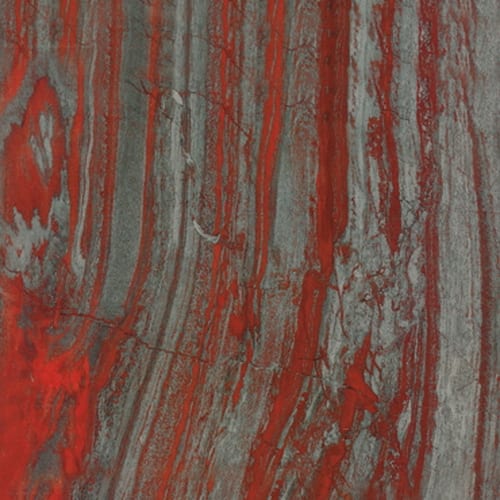 Iron Red granite slab face, photographed for the factory catalog — deep red overall.