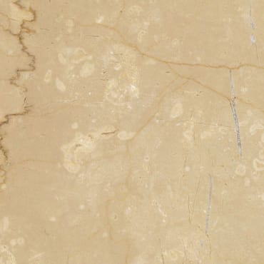 Botticino Classico marble slab face, photographed for the factory catalog — light amber overall.