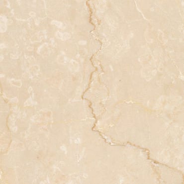 Botticino Semi Classico marble slab face, photographed for the factory catalog — near-white amber overall.