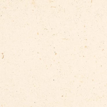 Creme Marfil Light marble slab face, photographed for the factory catalog — near-white amber overall.