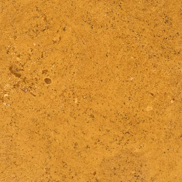 Giallo Gaya marble slab face, photographed for the factory catalog — mid-toned amber overall.