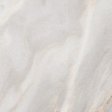 Palissandro Bluette Nuvolato Chiaro marble slab face, photographed for the factory catalog — near-white warm beige overall.